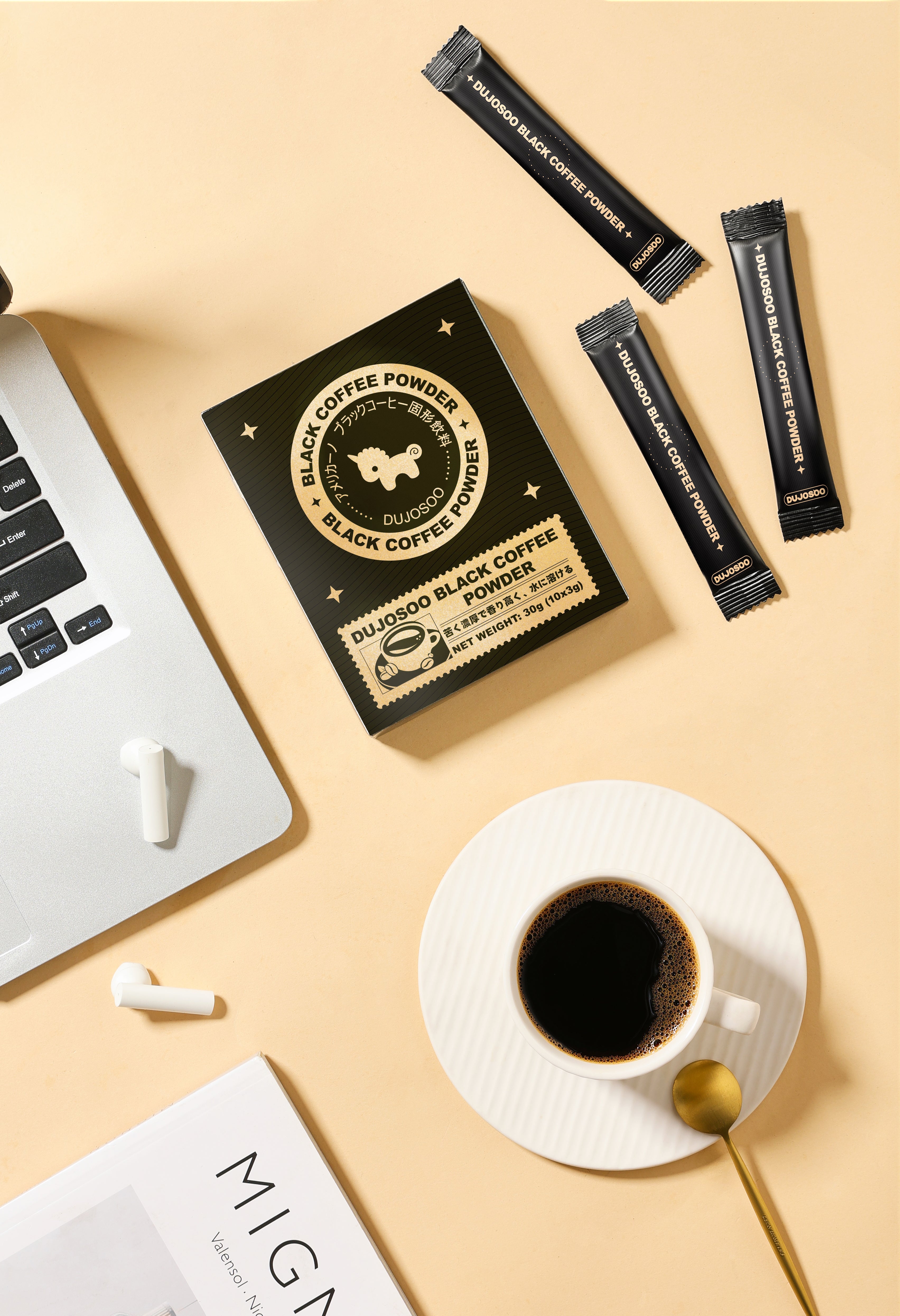 Black coffee sachets on a desk with coffee cup